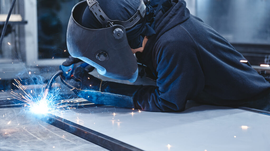 Welders On A Mission. Industrial labourer welding steel structure